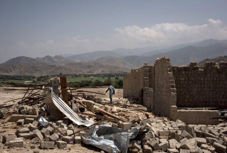 A boy walks through buildings damaged from fighting on July 15, 2017 in Shadal Bazaar, Afghanistan. (Andrew Renneisen/Getty Images)