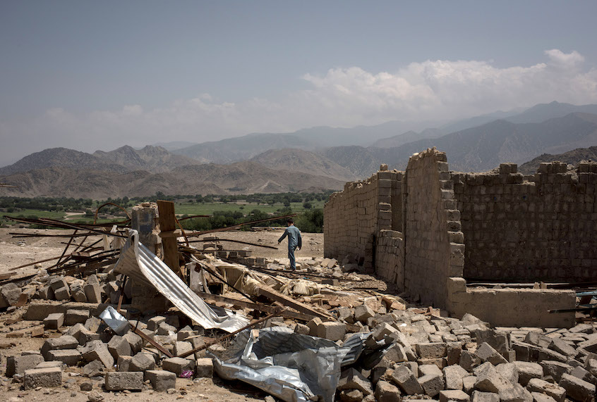 A boy walks through buildings damaged from fighting on July 15, 2017 in Shadal Bazaar, Afghanistan. (Andrew Renneisen/Getty Images)