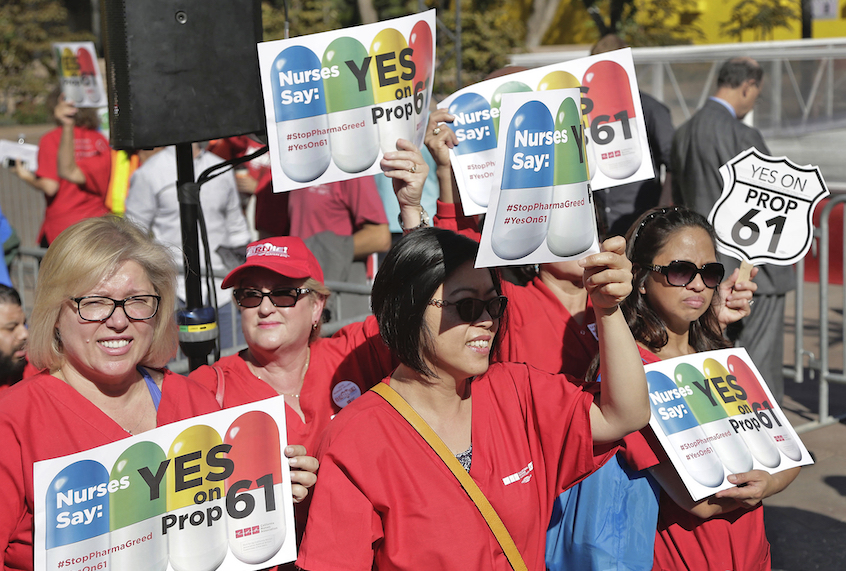 In this Nov. 7, 2016, file photo, nurses express support for a ballot proposition to limit what California state agencies pay for prescription drugs, during a rally with U.S. Sen. Bernie Sanders, I-Vt., in downtown Los Angeles. (AP Photo/Nick Ut, File)