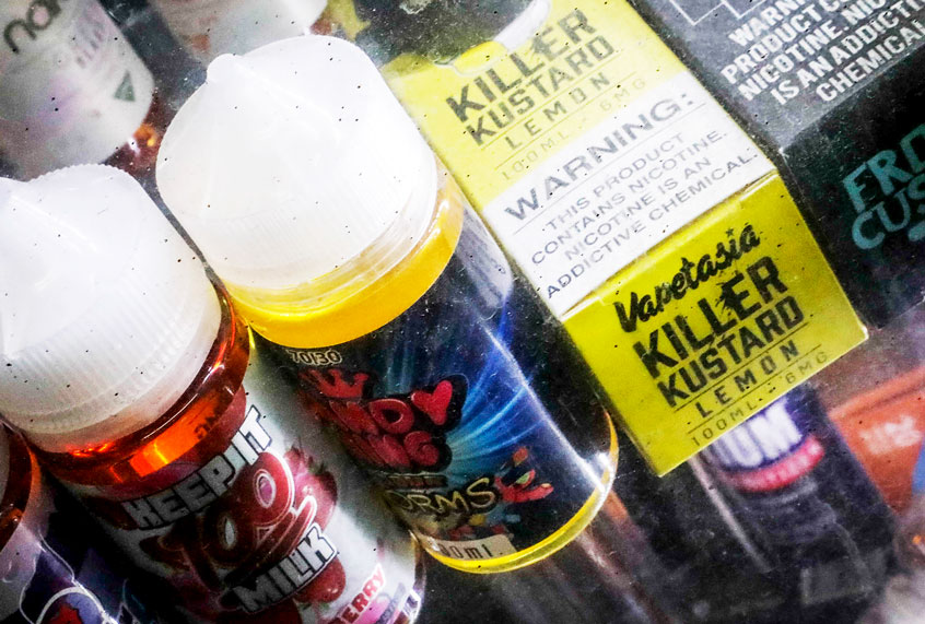 Flavored vaping solutions are shown in a window display at a vape and smoke shop, Monday Sept. 16, 2019, in New York. New York Gov. Andrew Cuomo is pushing to enact a statewide ban on the sale of flavored e-cigarettes amid growing health concerns of vaping. (AP Photo/Bebeto Matthews)
