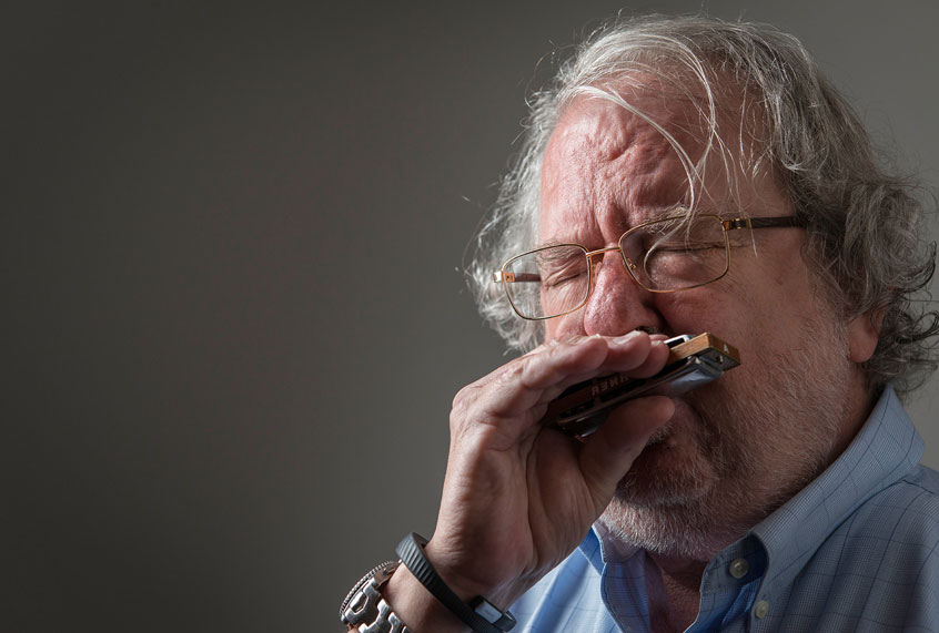 Jim Allison playing the harmonica (Uncommon Productions)