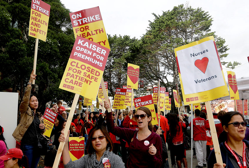 Registered nurses and supporters protest outside of a Kaiser Permanente facility in San Francisco, Tuesday, Nov. 11, 2014. (AP Photo/Jeff Chiu)