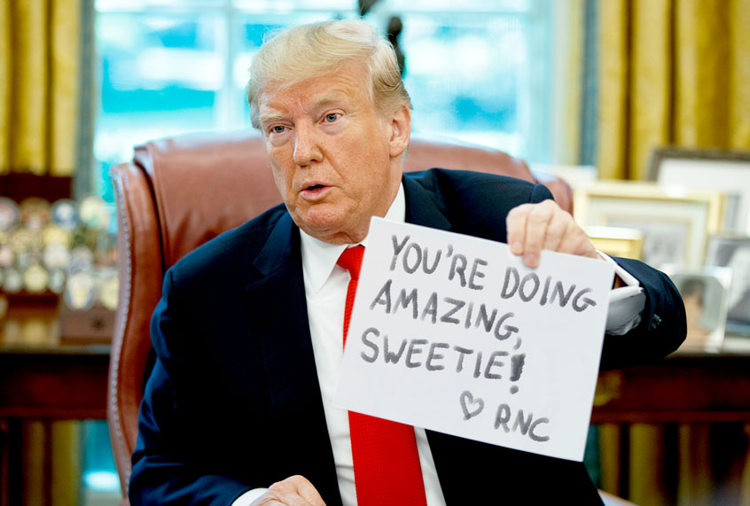 Donald Trump holding up a paper. (AP Photo/Evan Vucci/Salon)