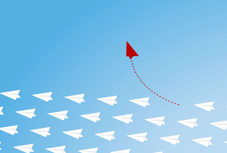 Red airplane changing direction (Getty Images/iStock)