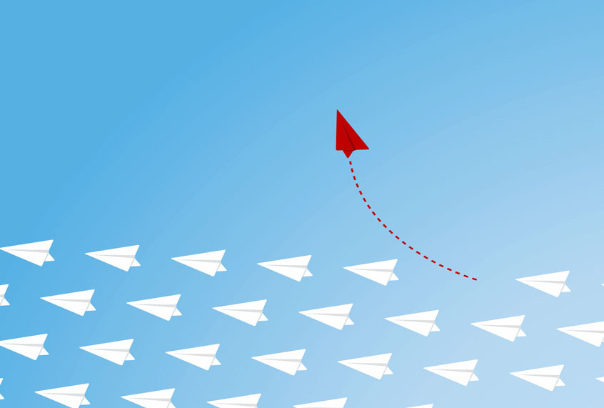 Red airplane changing direction (Getty Images/iStock)