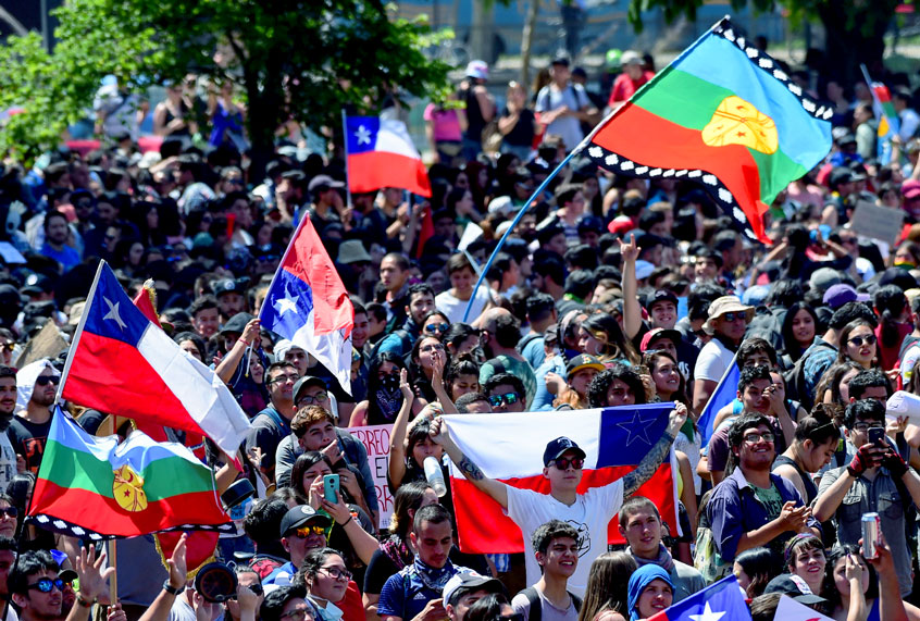 People demonstrate on the seventh day of widening protests over living costs and social inequality in Santiago, on October 24, 2019. - The United Nations said Thursday it would send a special mission to investigate human rights abuses in Chile, where a general strike went into its second day following a week of street protests that left 18 dead. (MARTIN BERNETTI/AFP via Getty Images)