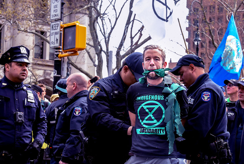 People are detained while participating in a direct action with a group protest organization called Extinction Rebellion on April 17, 2019 in New York City. The activists are demanding governments declare a climate emergency to combat pollution. (Stephanie Keith/Getty Images)