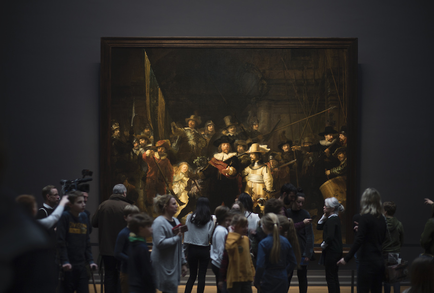 Visitors admire Rembrandt's Night Watch (1642), part of an exhibition of the all the Rijksmuseum's Rembrandts in Amsterdam, Netherlands, Wednesday, Feb. 13, 2019. (AP Photo/Peter Dejong)