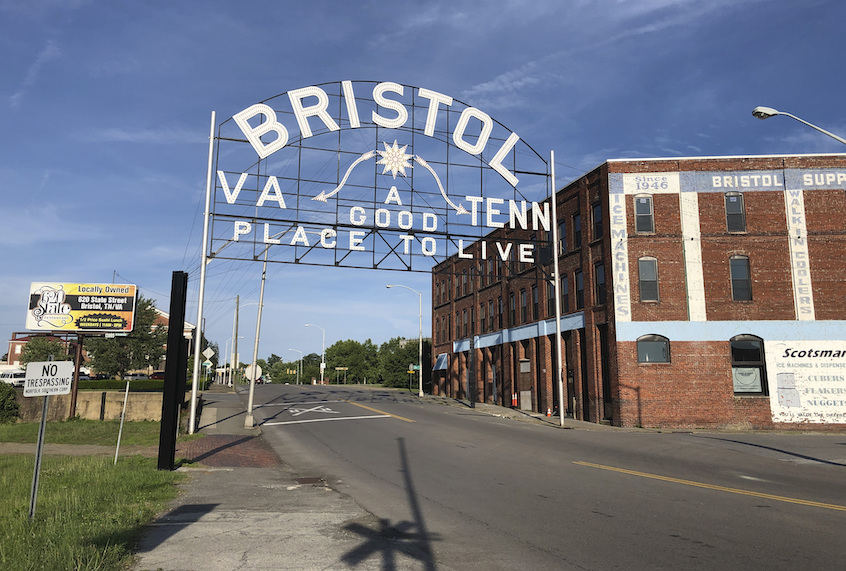 In this June 26, 2019 photo, A sign leading out of downtown Bristol, Va., a city that straddles two states, Tenn. and Va., is seen. (AP Photo/Sudhin Thanawala)