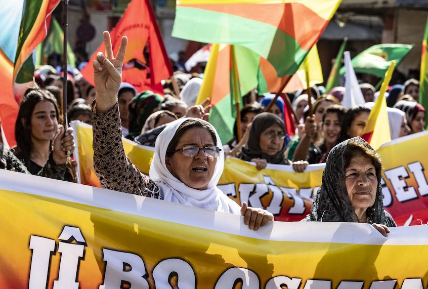 Syrian Kurdish women carry banners as they demonstrate against Turkish threats to launch a military operation on their region, in the town of Al-Qahtaniyah, in northeastern Syrian Al-Hasakah Governorate on October 7, 2019. (Delil Souleiman/AFP via Getty Images)