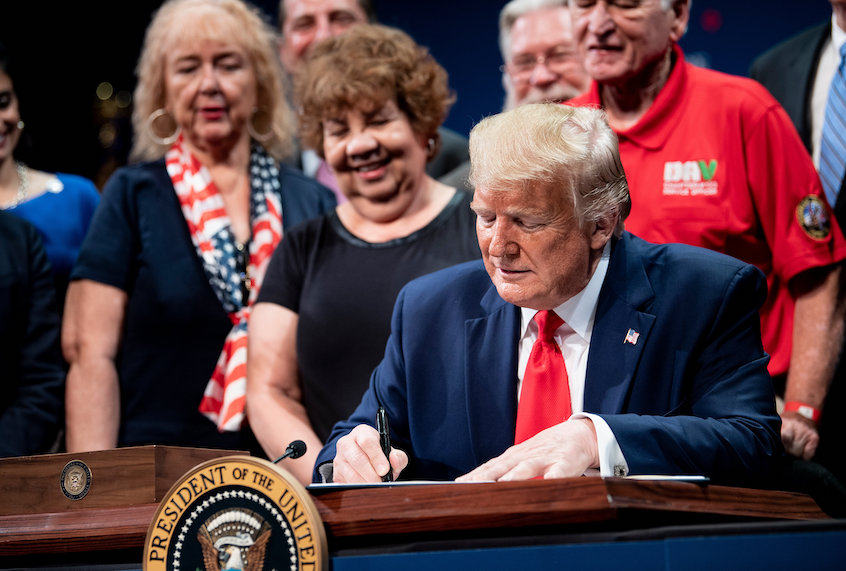 US President Donald Trump signs an executive order regarding Medicare at Sharon L. Morse Performing Arts Center October 3, 2019, in The Villages, Florida. (Brendan Smialowski/AFP via Getty Images)