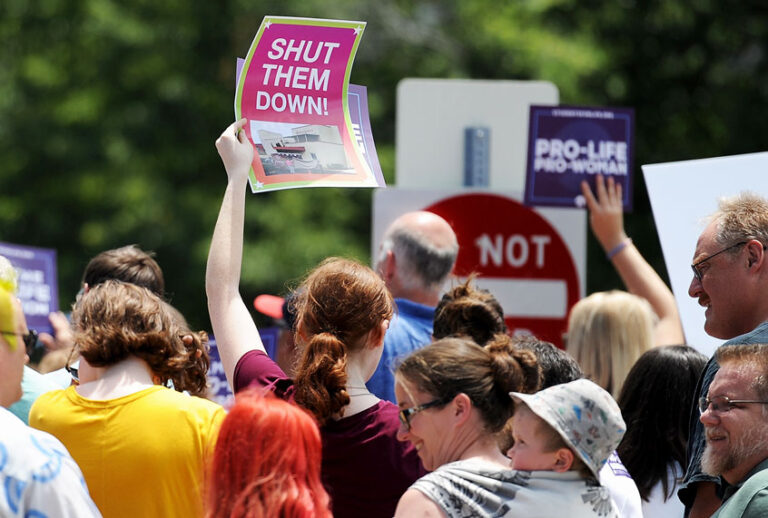 A group of demonstrators display signs during a pro-life rally outside the Planned Parenthood Reproductive Health Center (Michael B. Thomas/Getty Images)