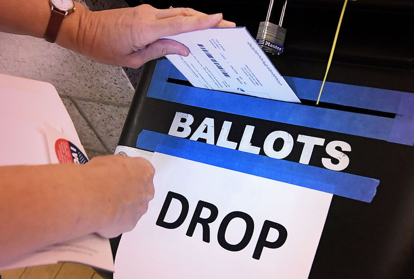 A woman places her ballot paper in the box during early voting (Getty Images/Mark Ralston)