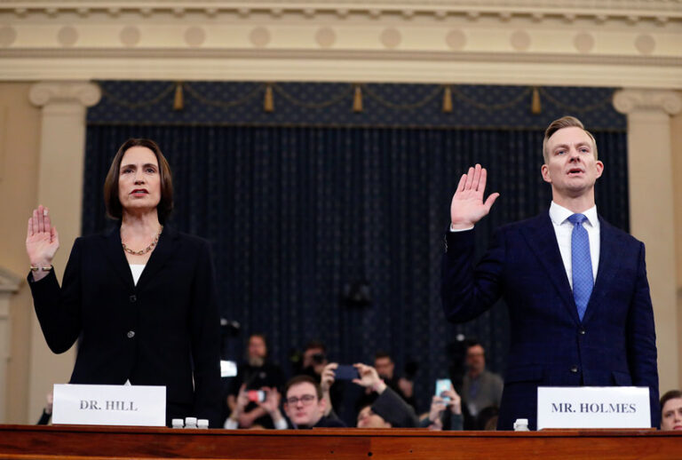 Former White House national security aide Fiona Hill, left, and David Holmes, a U.S. diplomat in Ukraine, are sworn in to testify before the House Intelligence Committee on Capitol Hill in Washington, Thursday, Nov. 21, 2019, during a public impeachment hearing of President Donald Trump's efforts to tie U.S. aid for Ukraine to investigations of his political opponents. (AP Photo/Andrew Harnik)