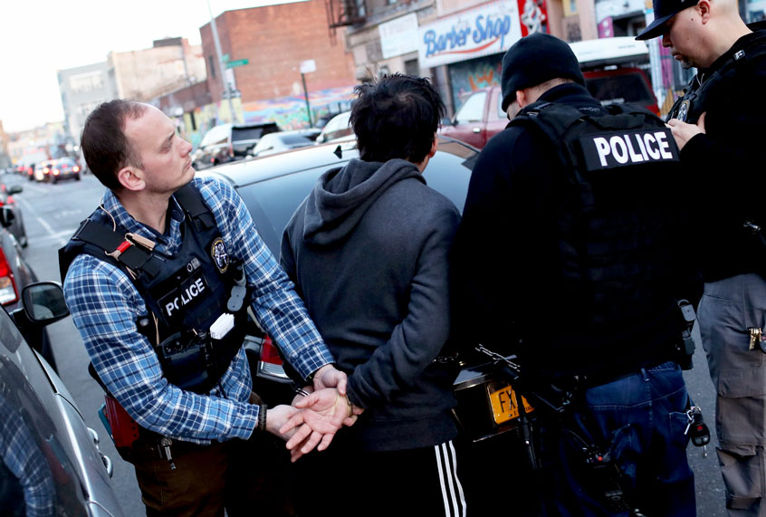U.S. Immigration and Customs Enforcement (ICE), officers arrest an undocumented Mexican immigrant during a raid (John Moore/Getty Images)