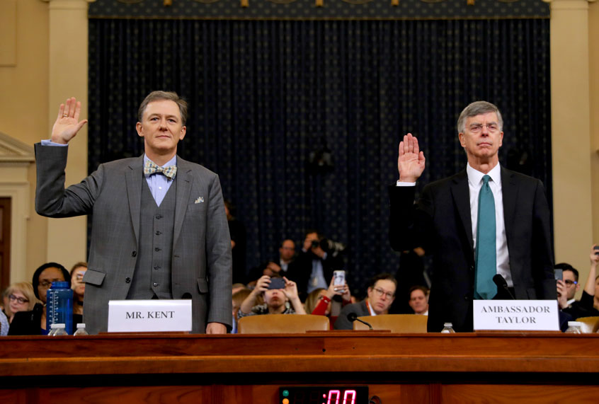 Deputy Assistant Secretary for European and Eurasian Affairs George P. Kent (L) and top U.S. diplomat in Ukraine William B. Taylor Jr. are sworn in before testifying before the House Intelligence Committee in the Longworth House Office Building on Capitol Hill November 13, 2019 in Washington, DC. In the first public impeachment hearings in more than two decades, House Democrats are trying to build a case that President Donald Trump committed extortion, bribery or coercion by trying to enlist Ukraine to investigate his political rival in exchange for military aide and a White House meeting that Ukraine President Volodymyr Zelensky sought with Trump. (Chip Somodevilla/Getty Images)