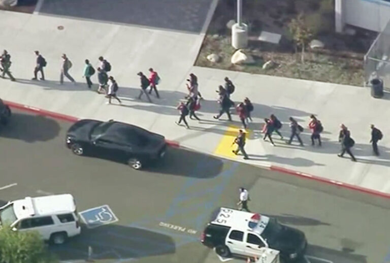 People are lead out of Saugus High School after reports of a shooting on Thursday, Nov. 14, 2019 in Santa Clarita, Calif. The Los Angeles County Sheriff’s Department says on Twitter that deputies are responding to the high school about 30 miles (48 kilometers) northwest of downtown Los Angeles. The sheriff’s office says a male suspect in black clothing was seen at the school. (KTTV-TV via AP)