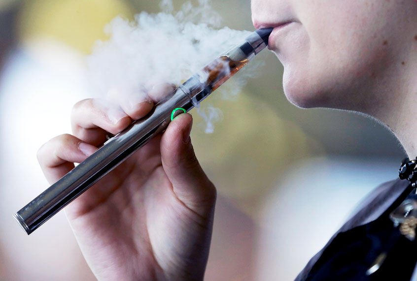 A woman using an electronic cigarette (AP Photo/Tony Dejak)