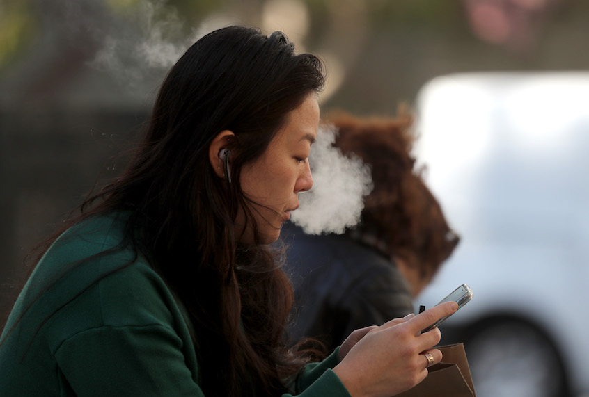 SAN FRANCISCO, CALIFORNIA - NOVEMBER 08: A pedestrian smokes an e-cigarette on November 08, 2019 in San Francisco, California. The Center for Disease Control (C.D.C.) has reported that an additive sometimes used in vaping products known as vitamin E acetate may be the cause of a national outbreak of e-cigarette-related lung injuries that has been linked to dozens of deaths. (Photo by Justin Sullivan/Getty Images) (Justin Sullivan/Getty Images)