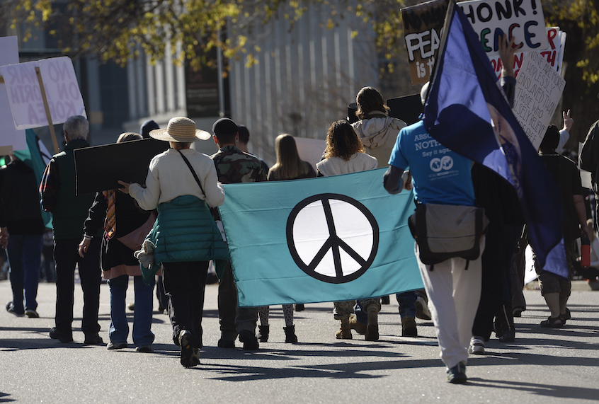 Members of Veterans for Peace and About Face: Veterans Against the War, march down Lincoln Street during the Denver Veterans Day Parade, hosted by the Colorado Veterans Project in downtown on November 11, 2017 in Denver, Colorado. The parade, comprised of local veterans organizations, lines Civic Center Park and nearby streets and is broken down into serials that represent a different conflict in military history. (Kathryn Scott/The Denver Post via Getty Images)
