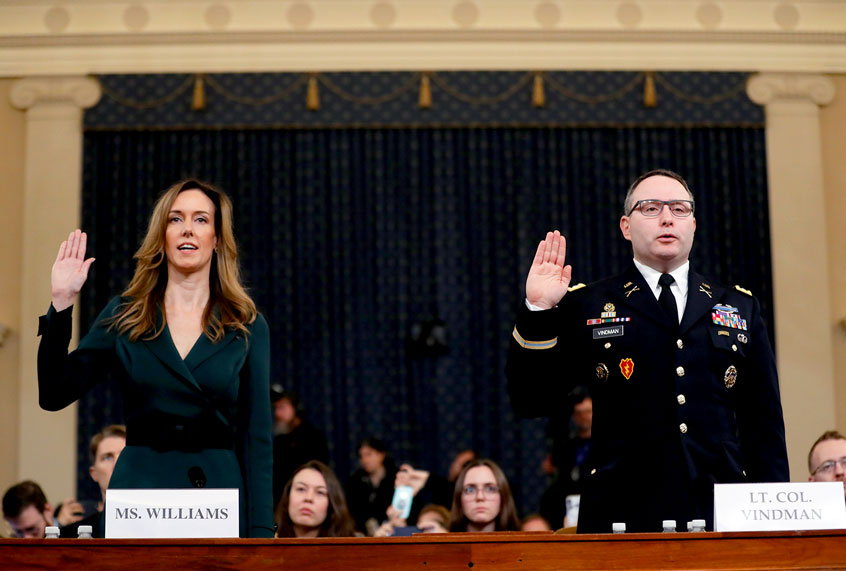 Jennifer Williams, an aide to Vice President Mike Pence, left, and National Security Council aide Lt. Col. Alexander Vindman, are sworn in to testify before the House Intelligence Committee on Capitol Hill in Washington, Tuesday, Nov. 19, 2019, during a public impeachment hearing of President Donald Trump's efforts to tie U.S. aid for Ukraine to investigations of his political opponents. (AP Photo/Andrew Harnik)