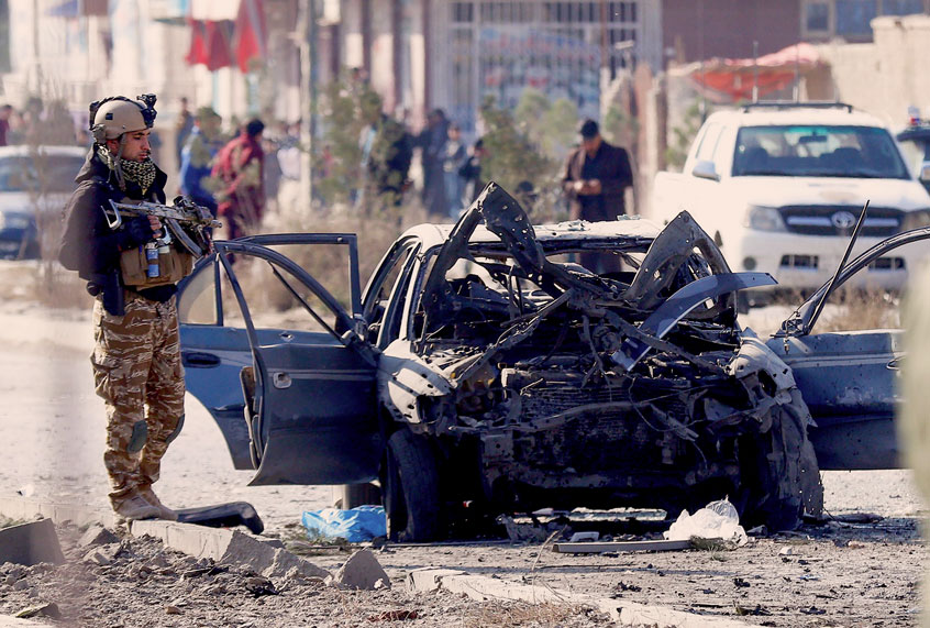 A soldier stands next to the site of a suicide attack in Kabul on November 13, 2019. - At least seven people were killed and seven wounded when a car bomb detonated during Kabul's busy morning rush hour on November 13, an interior ministry spokesman said. (Photo by STR / AFP) (Photo by (STR/AFP via Getty Images)