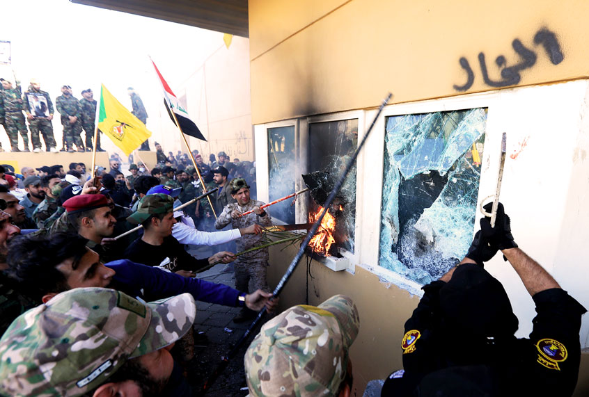 Outraged Iraqi protesters storm the U.S. Embassy in Baghdad, protesting Washington's attacks on armed battalions belong to Iranian-backed Hashd al-Shaabi forces on December 31, 2019. At least 25 people were killed in weekend U.S. airstrikes on positions of Kataib Hezbollah, an Iranian-backed militia group, in Iraq and Syria. Hundreds of Iraqi protesters gathered early Tuesday near the embassy to show their anger at the U.S. move. (Photo by (Murtadha Sudani/Anadolu Agency via Getty Images)