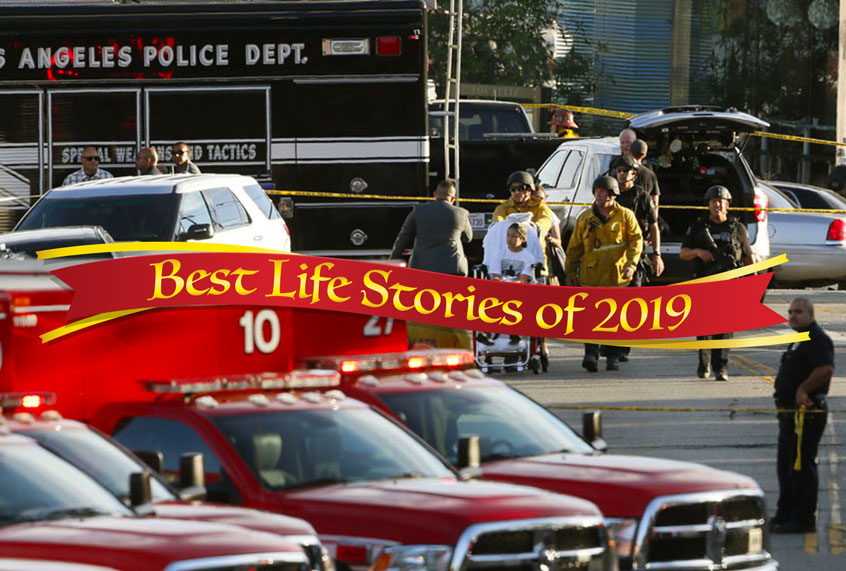 Los Angeles Police SWAT officers, and Los Angeles firemen wearing bulletproof helmets, evacuate a child, after a gunman barricaded himself inside a Trader Joe's store in Los Angeles, July 21, 2018. (AP/Damian Dovargane)