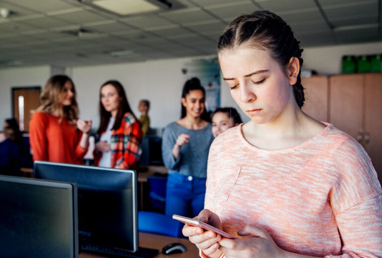 A teenage student is the victim of cyber bullying, looking sad (Getty Images/SolStock)