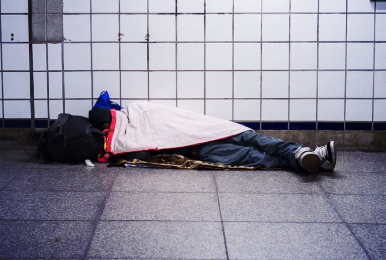 A homeless individual sleeps in a subway station in New York (Richard Levine/Corbis via Getty Images)