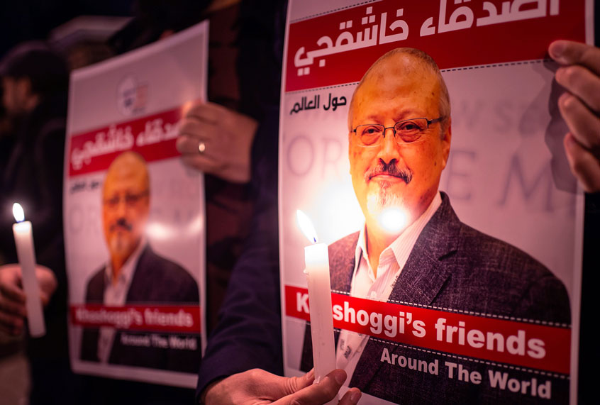 People hold posters picturing Saudi journalist Jamal Khashoggi and lightened candles during a gathering outside the Saudi Arabia consulate in Istanbul, on October 25, 2018. - Jamal Khashoggi, a Washington Post contributor, was killed on October 2, 2018 after a visit to the Saudi consulate in Istanbul to obtain paperwork before marrying his Turkish fiancee. (YASIN AKGUL/AFP via Getty Images)