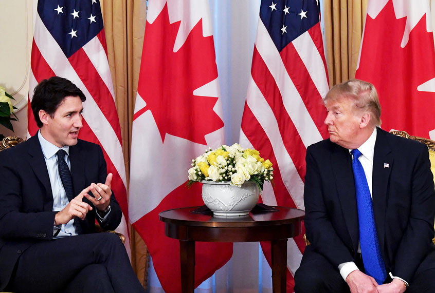 Former President Donald Trump listens to Canada's Prime Minister Justin Trudeau during a meeting at Winfield House, London on December 3, 2019. (NICHOLAS KAMM/AFP via Getty Images)
