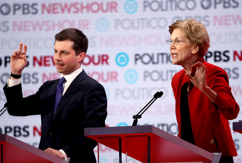 Sen. Elizabeth Warren (D-MA) speaks as South Bend, Indiana Mayor Pete Buttigieg raises his hand during the Democratic presidential primary debate at Loyola Marymount University on December 19, 2019 in Los Angeles, California. Seven candidates out of the crowded field qualified for the 6th and last Democratic presidential primary debate of 2019 hosted by PBS NewsHour and Politico. (Justin Sullivan/Getty Images)