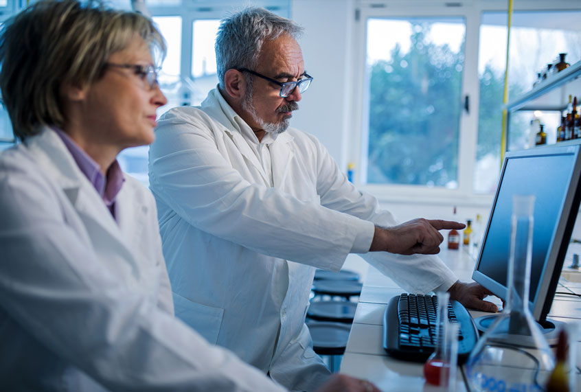 Scientists doing research on desktop PC in a laboratory. (Getty Images)