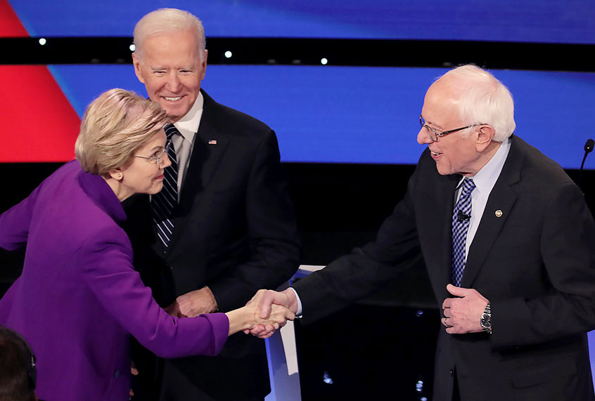 Sen. Elizabeth Warren (D-MA) greets Sen. Bernie Sanders (I-VT) (R) as former Vice President Joe Biden looks on ahead of the Democratic presidential primary debate at Drake University on January 14, 2020 in Des Moines, Iowa. Six candidates out of the field qualified for the first Democratic presidential primary debate of 2020, hosted by CNN and the Des Moines Register. (Scott Olson/Getty Images)