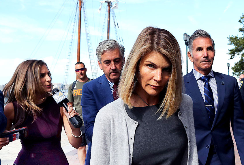 Lori Loughlin, center, and her husband Mossimo Giannulli, behind her at right, leave the John Joseph Moakley United States Courthouse in Boston (John Tlumacki/The Boston Globe via Getty Images)