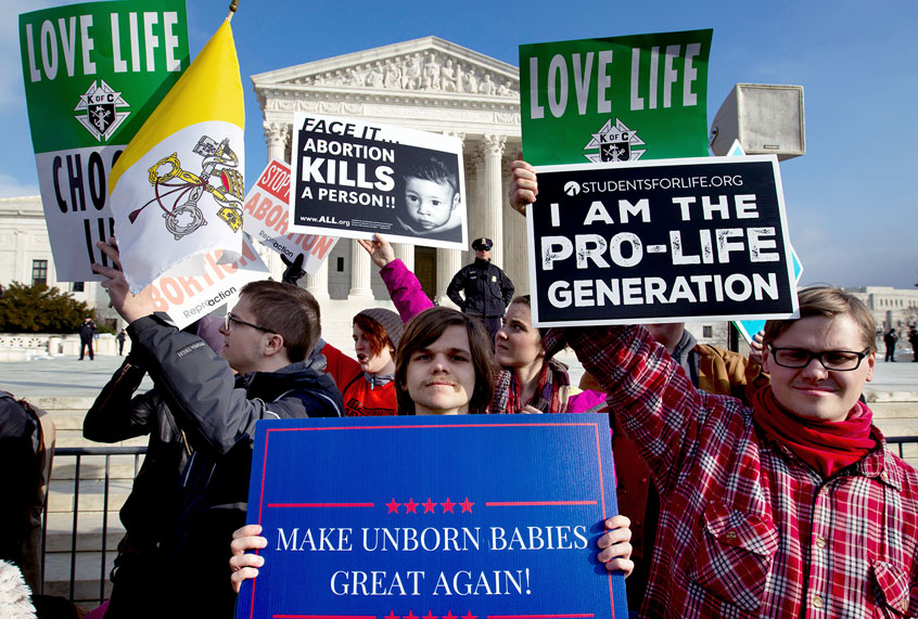 In this Friday, Jan. 18, 2019 file photo, anti-abortion activists protest outside of the U.S. Supreme Court, during the March for Life in Washington. President Trump's call for a ban on late-term abortions is unlikely to prevail in Congress, but Republican legislators in several states are pushing ahead with tough anti-abortion bills of their own that they hope can pass muster with the reconfigured U.S. Supreme Court. (AP Photo/Jose Luis Magana)