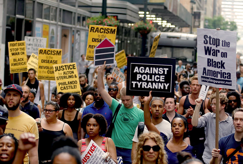 People hold banners and chant slogans as they march from Union Square Park to Grand Central to protest the killing of 3 black men by police in 48 hours, in Manhattan, New York on July 7, 2016. (Volkan Furuncu/Anadolu Agency/Getty Images)