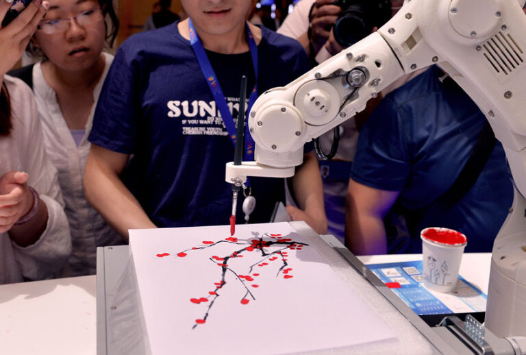 People watch an intelligent robot painting during the opening of the 3rd World Intelligence Congress (WIC) at the Meijiang Convention & Exhibition Center on May 16, 2019 in Tianjin, China. The 3rd WIC with the theme of 'Intelligence New Era: Progress, Planning and Opportunity' is held on May 16-19 in Tianjin. (Visual China Group via Getty Images)