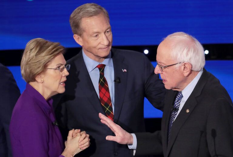 Sen. Elizabeth Warren (D-MA) and Sen. Bernie Sanders (I-VT) speak as Tom Steyer looks on after the Democratic presidential primary debate at Drake University on January 14, 2020 in Des Moines, Iowa. Six candidates out of the field qualified for the first Democratic presidential primary debate of 2020, hosted by CNN and the Des Moines Register. (Scott Olson/Getty Images)