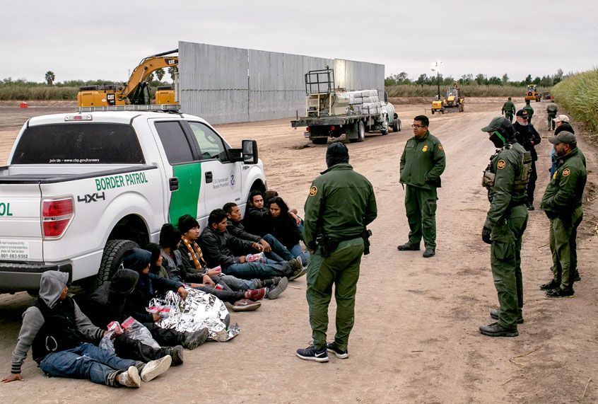 U.S. Border Patrol agents detain undocumented immigrants caught near a section of privately-built border wall under construction on December 11, 2019 near Mission, Texas. The hardline immigration group We Build The Wall is funding construction of the wall on private land along the Rio Grande, which forms the border with Mexico. The group, led by former Trump strategist Stephen Bannon claims to have raised tens of millions of dollars in a GoFundMe drive to build sections of wall along stretches of the U.S. southwest border with Mexico. (John Moore/Getty Images)