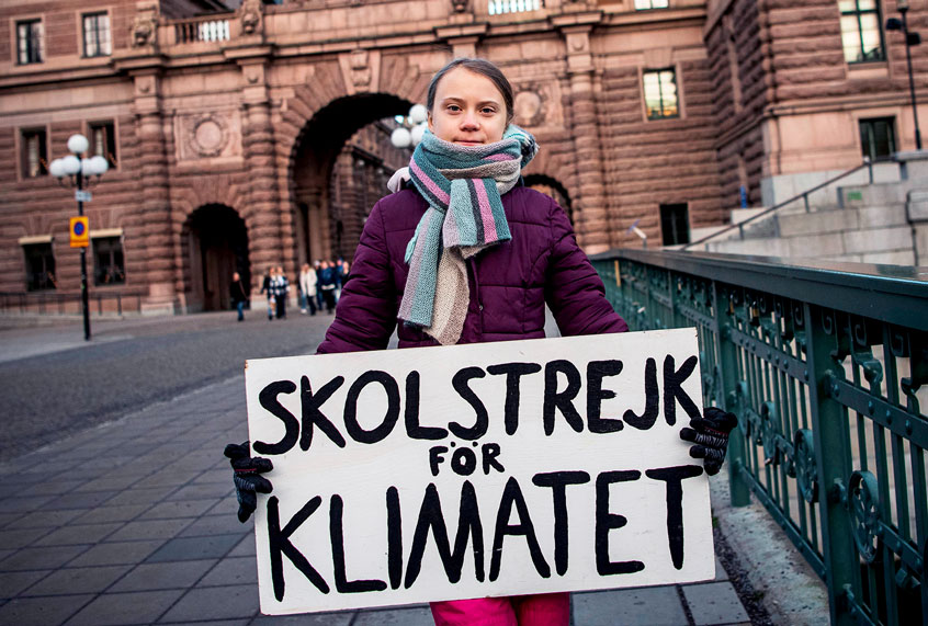 17-years-old Swedish climate activist Greta Thunberg holds a poster reading "School strike for Climate" as she protests in front of the Swedish Parliament, where she goes on school strike on January 10, 2020 in Stockholm. (JONATHAN NACKSTRAND/AFP via Getty Images)
