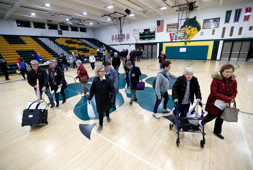 Local residents enter an Iowa Democratic caucus at Hoover High School, Monday, Feb. 3, 2020, in Des Moines, Iowa. (AP Photo/Charlie Neibergall)