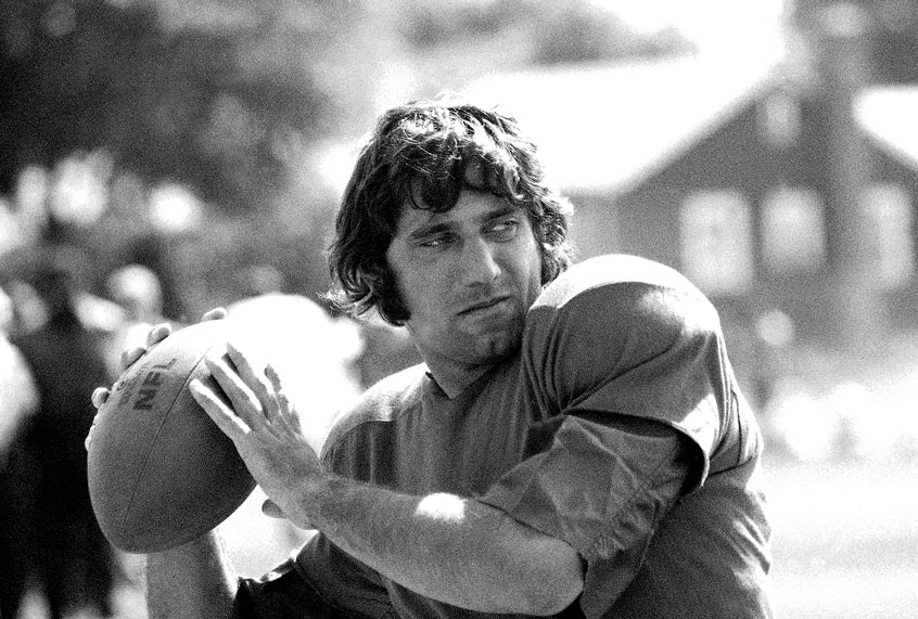 New York Jets' quarterback Joe Namath practices hurling the ball at the team's training camp at Hofstra University on Long Island, Aug. 18, 1970. Earlier Namath said he didn?t think he could play ball this season, blaming both business and physical problems for his statement. Namath checked into the training camp on August 18 after almost two weeks' being listed as AWOL. (AP Photo/Harry Harris)