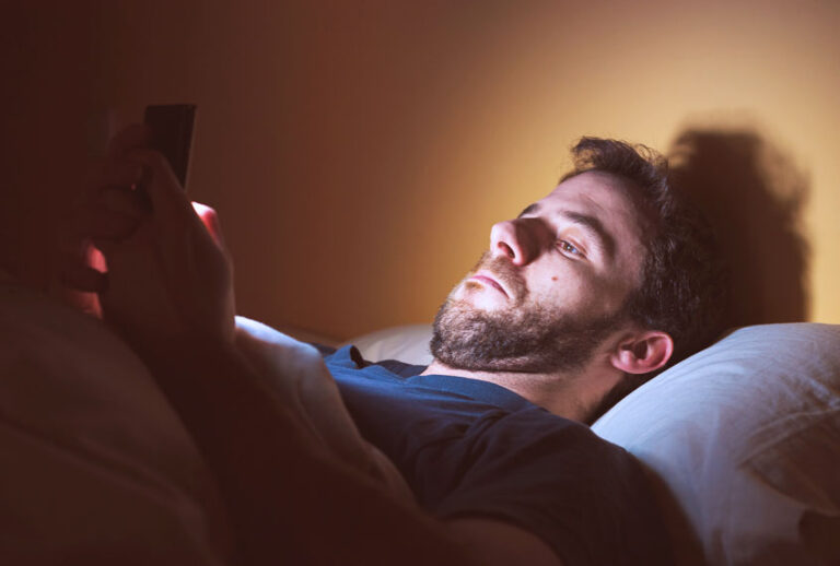 Man looking through apps on his smartphone (Getty Images)