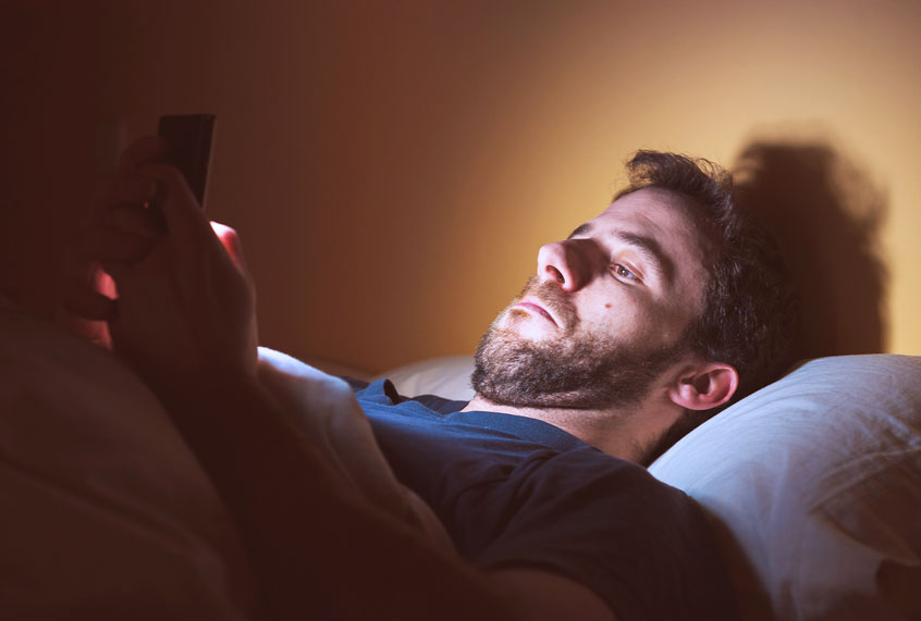 Man looking through apps on his smartphone (Getty Images)
