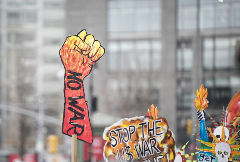 A marcher holds a sign that says "NO WAR" with a closed fist as protest outside of Trump International Tower during the Woman's March in the borough of Manhattan in NY on January 18, 2020, USA. (Ira L. Black/Corbis via Getty Images)