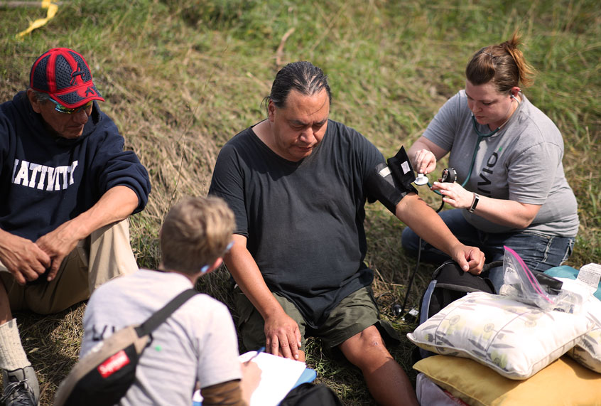 A team of nurses with Livio Health Group took the vital signs of Anthony Nichols 52, at the large homeless camp Monday September 24, 2018 in Minneapolis, MN. Nichols said that he has a heart condition and had not been taking his medicine; he was later transported to local hospital by ambulance. Nichols said that he had been staying at the camp for only two days. (Jerry Holt/Star Tribune via Getty Images)