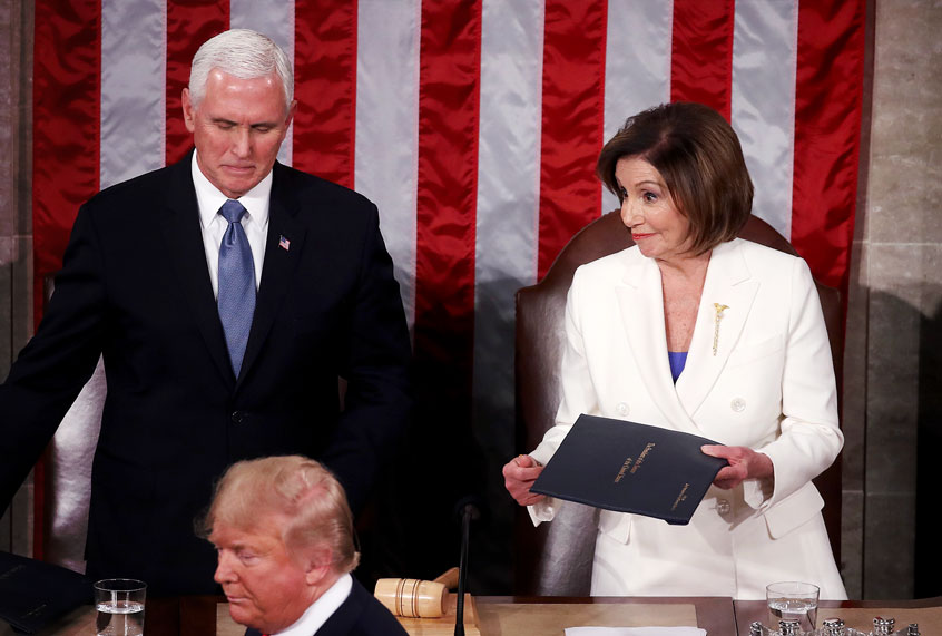 House Speaker Rep. Nancy Pelosi (D-CA) and Vice President Mike Pence look on as President Donald Trump steps to the lectern for the State of the Union address in the chamber of the U.S. House of Representatives on February 04, 2020 in Washington, DC. President Trump delivers his third State of the Union to the nation the night before the U.S. Senate is set to vote in his impeachment trial. (Mark Wilson/Getty Images)