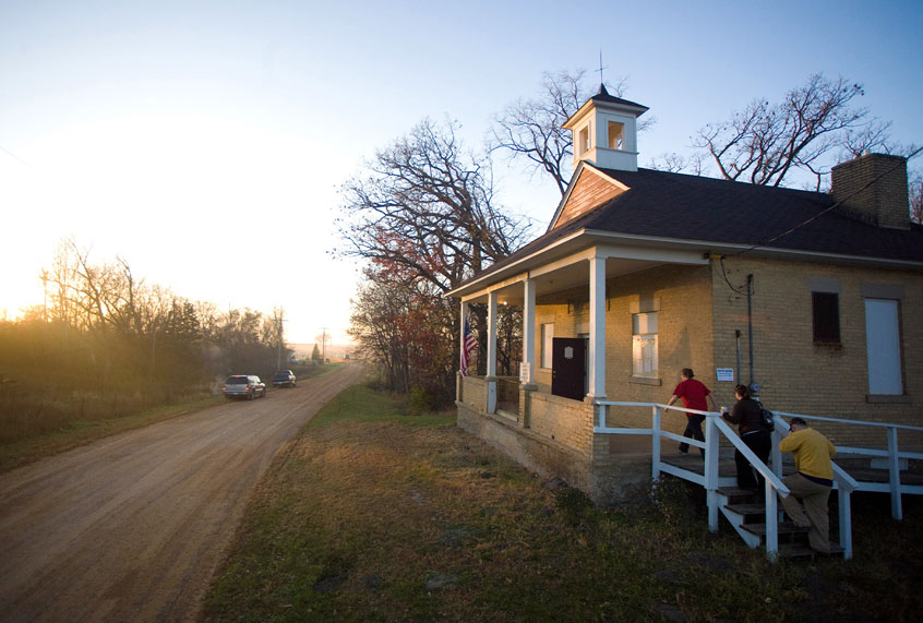 People enter the town hall just after sunrise to cast their ballot in the US presidential election on November 4, 2008 in the rural township of San Francisco, Minnesota. The town hall, which is a converted one room school house, serves as the polling location for the township. (Cory Ryan/Getty Images)